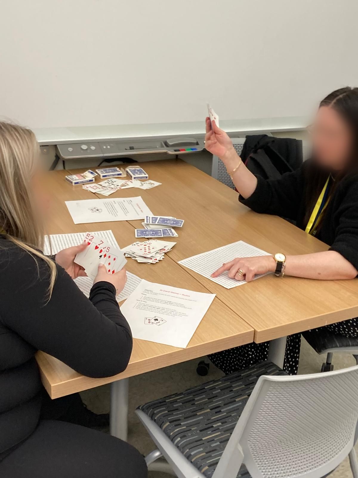 2 women playing pi card game