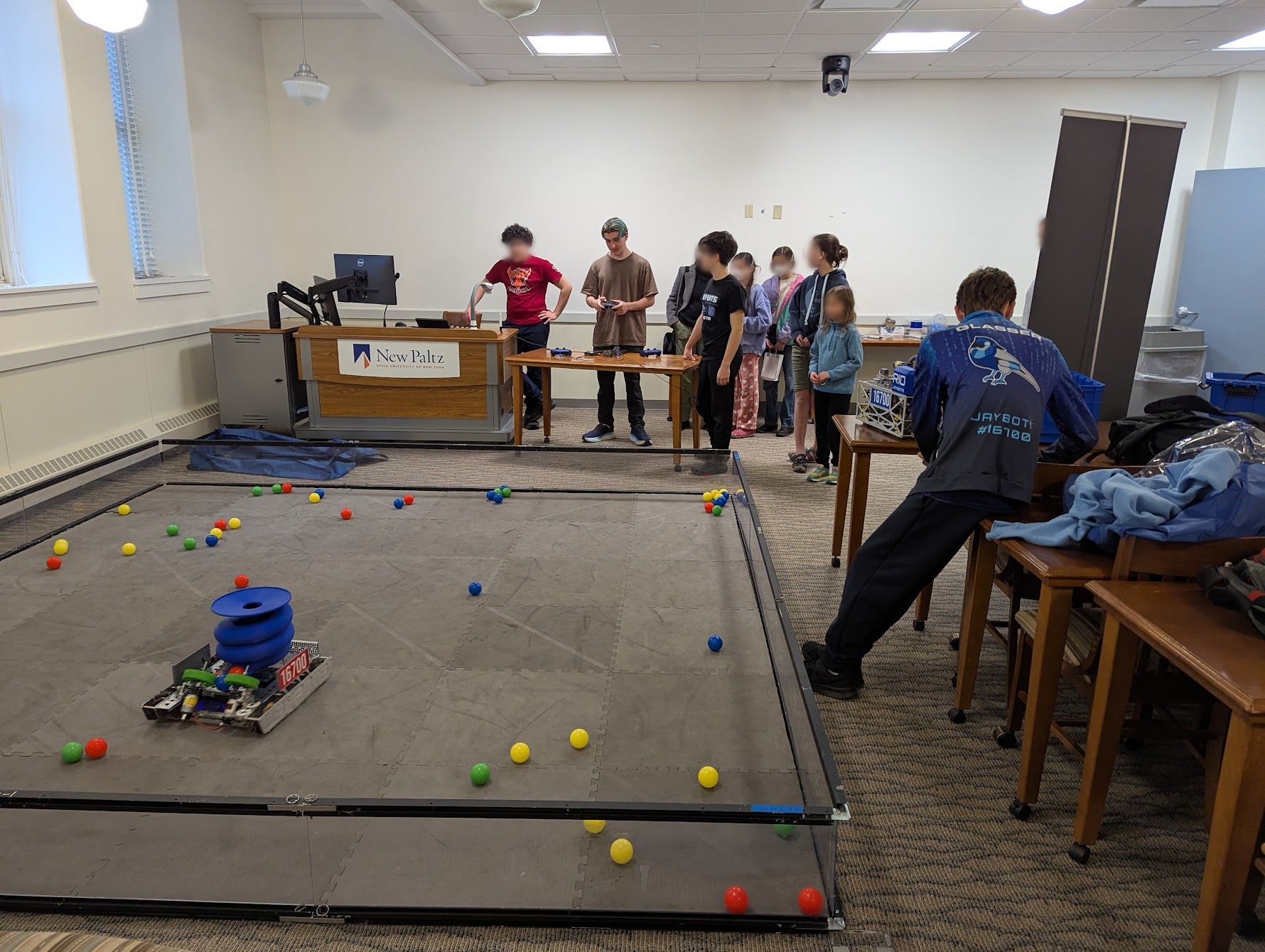 People around ball pit with robot